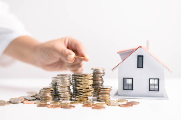 istock Investment in a home often involves securing a mortgage loan, with a finance agent helping to manage business and property aspects of the house to ensure best use of your money. investment, loan. 2164132890