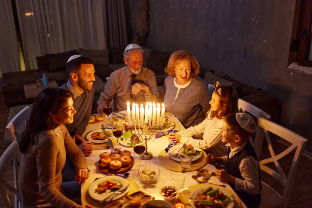 istock Happy multi-generation family talking during dinner on Hanukkah. 2164135119