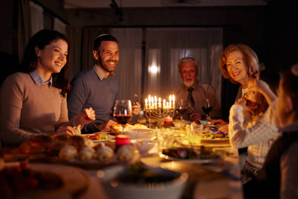 istock Happy extended family talking during a meal on Hanukkah. 2164135183
