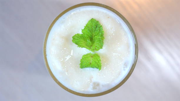 istock Refreshing mint smoothie in glass, view from above, garnished with 2164135579