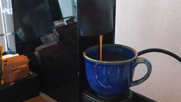 istock Blue mug with freshly brewed coffee from espresso machine in cozy 2164135800