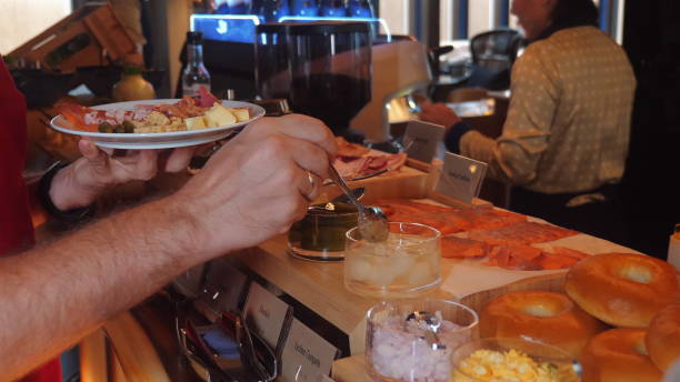 istock Hands serving variety of appetizers and snacks at buffet, showcasing 2164136679