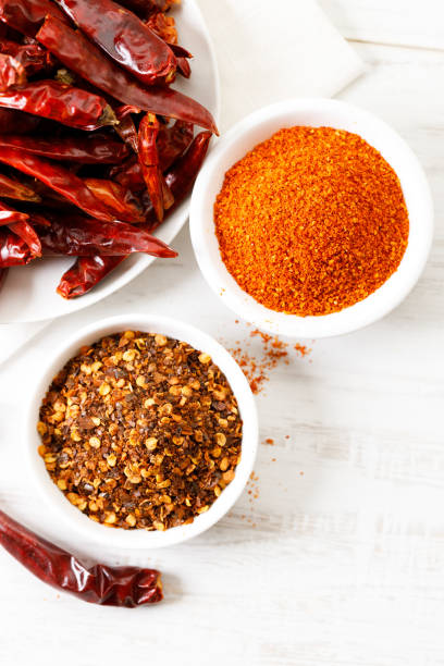 istock Dried red chilies on white wooden table. 2164137364