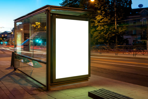Mockup Of Bus Stop Advertising Billboard In City Street At Night Mockup Of Bus Stop Advertising Billboard In City Street At Night. Poster Light Box With Car Light Streaks bus shelter stock pictures, royalty-free photos & images