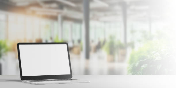 istock A laptop with a blank screen sits on desk blur office interior. 2164142773