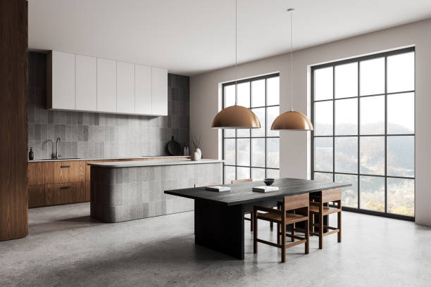istock Modern kitchen and dining area with large windows, concrete flooring, and minimalist design, furniture and decor. Interior design concept. 3D Rendering 2164147343
