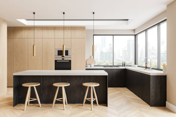 istock Modern kitchen interior with light wood cabinets, black countertops, and city view through large windows, concept of apartment living. 3D Rendering 2164148050