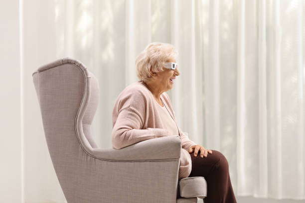 istock Elderly lady with a pair of 3D glasses 2164150031
