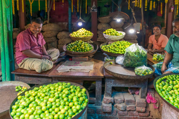 India, West Bengal, Kolkata, Bow Bazaar. Man selling limes.