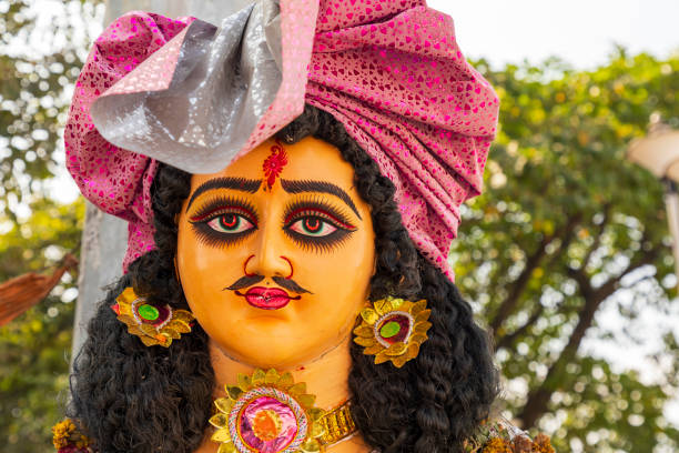 India, West Bengal, Kolkata, B B D Bagh. Colorfully painted statue with man's head.