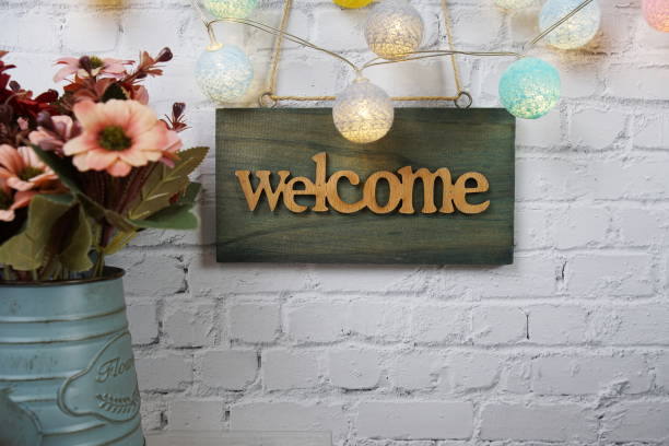 istock Welcome sign Hanging on grunge cement wall background 2164153168