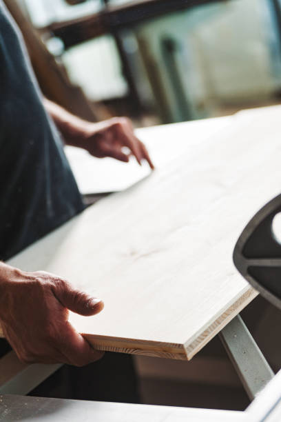 istock Carpenter checking wood plank quality in his workshop 2164154199