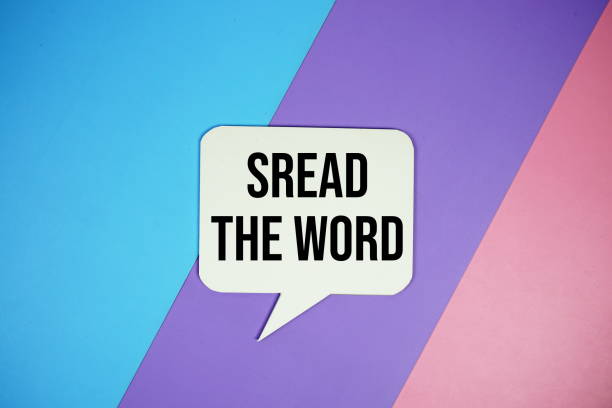 istock Spread The Word text on speech bubble top view on blue, purple and pink geometric background 2164154593