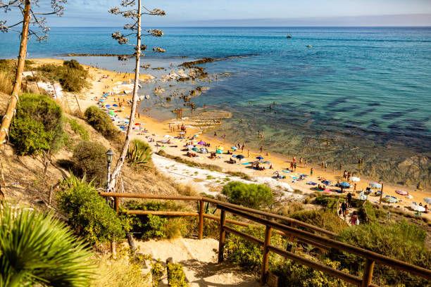 istock Aerial view of white marl cliffs at Agrigento beach with people resting besides Scala dei turchi or Stair of the turks, Sicily. Summer vacation, blue sea, Italy. 2164154721