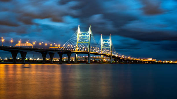 istock Illuminated Cable-Stayed Bridge Over Water at Night with City Skyline 2164155700
