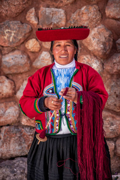 istock Peruvian woman spinning wool by hand, Sacred Valley, Peru 2164156345