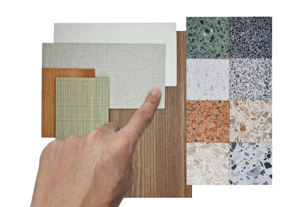istock interior architect choosing material samples including multi color of terrazzo stones, oak wooden laminated, wooden veneer, fabric laminateds isolated on background with clipping path, top view. 2164159094
