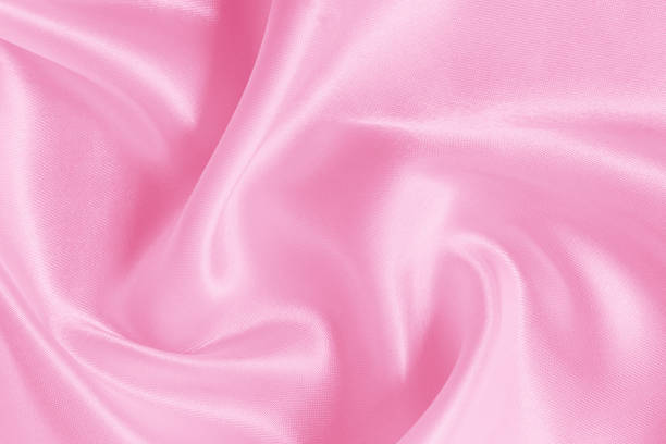 Pink fabric cloth texture for background and design art work, beautiful crumpled pattern of silk or linen.