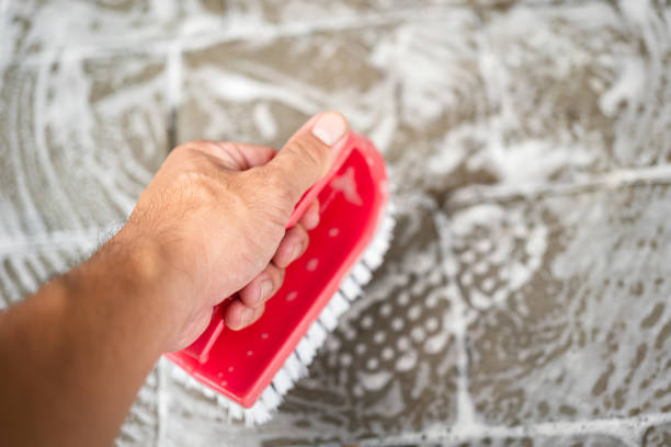 Cleaning parquet with yellow cloth