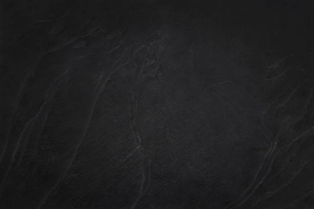 Dark grey black slate texture in natural pattern with high resolution for background and design art work. Black stone wall.