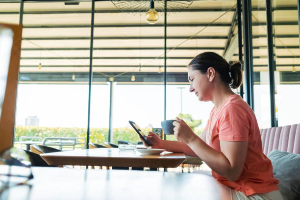 istock Happy Young Woman with Mobile Phone and Coffee 2164161021
