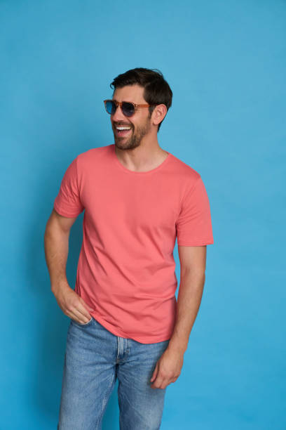istock Cheerful man with sunglasses is posing with his hand in his pocket 2164161960