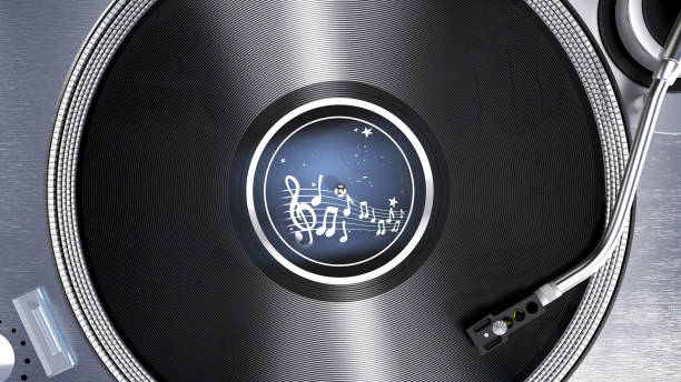 A beautifully designed turntable features a spinning vinyl record in the center, showcasing intricate details and a sleek metallic finish. Surrounding elements include various controls and knobs, enhancing the modern aesthetic of the setup. The ambient lighting subtly reflects off the surface, creating a warm atmosphere perfect for enjoying music.