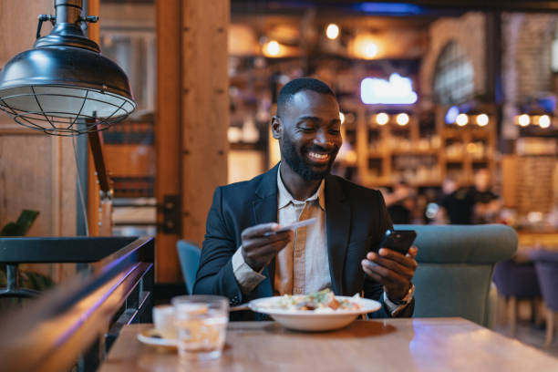 istock Dining and interacting with phone at restaurant. 2164166503