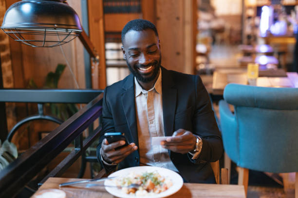 istock Man dining with phone at cozy restaurant. 2164166530