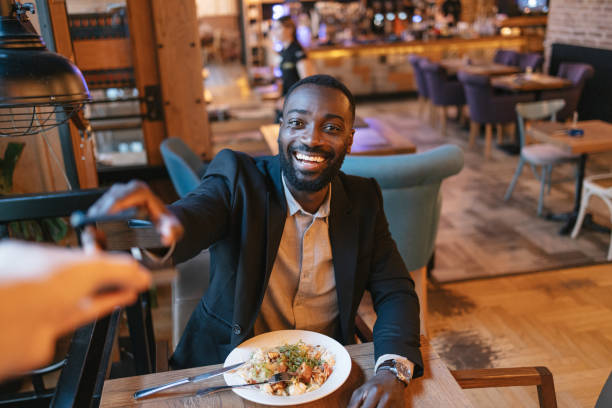 istock Man handing credit card at a restaurant table 2164166672
