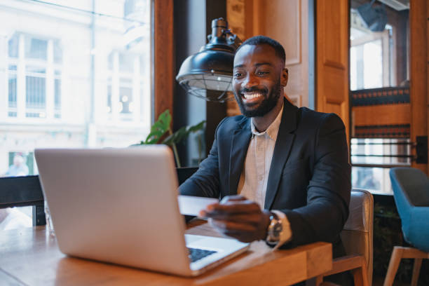 istock Man joyously working on laptop at trendy restaurant 2164166763