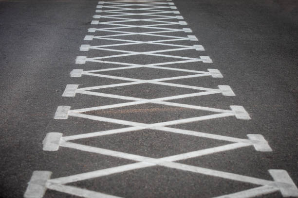 White painted lines on asphalt for road traffic.