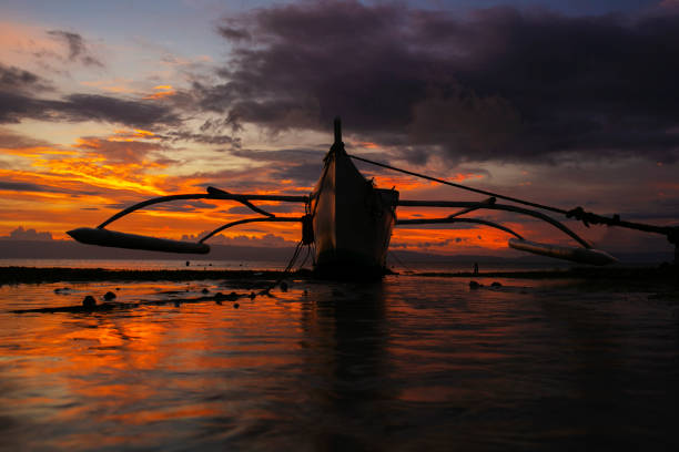 istock Small Fishing Boat and a Beautiful Sunset 2164168415