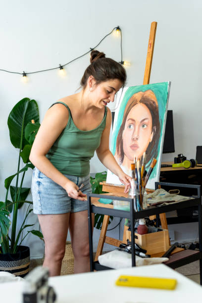 istock Artist working on a portrait in a stylish studio 2164168491