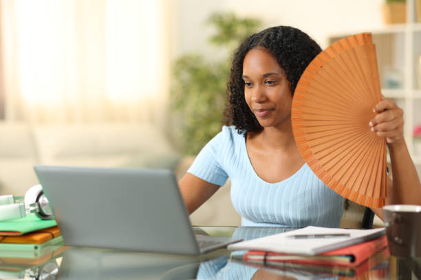 istock Black student learning and fanning a hot day 2164169500