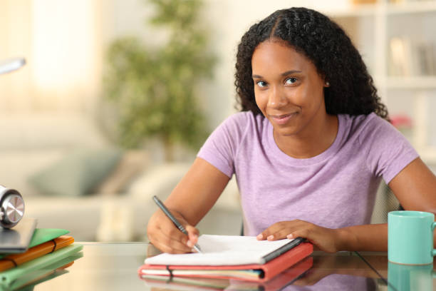 istock Proud black student looking at you learning at home 2164169518