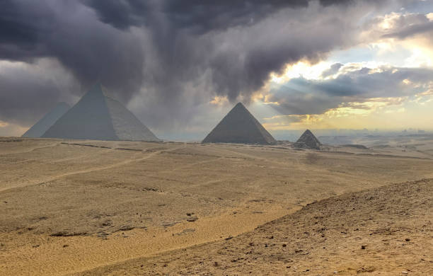 istock dramatic cloudscape pyramids of giza, egypt 2164170935