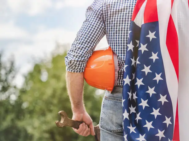 Attractive man and American Flag. Labor and employment concept Attractive man and American Flag. Labor and employment concept