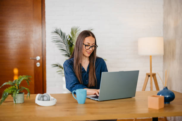 istock Young Woman Drinking Coffee While Working On A Laptop In The Home Office 2164180836