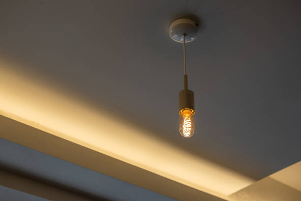 istock Hanging Edison light bulb, also known as filament light bulb. with ceiling cove lighting detail 2164182494
