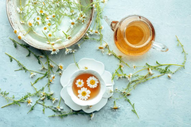 istock Chamomile flower tea. A tea cup and a tea pot with fresh medicinal flowers 2164182619