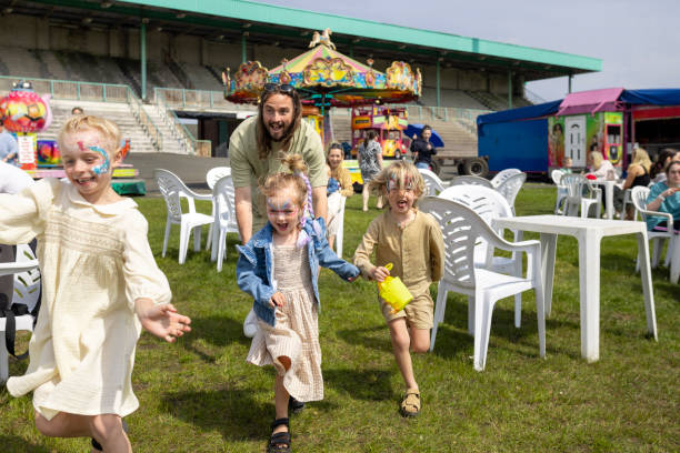 istock Dad Playing with his Children at the Fair 2164186002