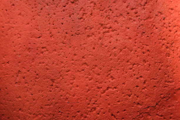 Close-up texture of a red painted rough surface