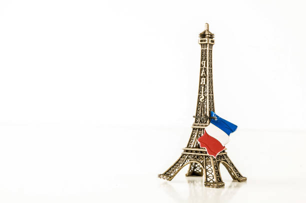 A small model of the Eiffel Tower with a red and white flag on top