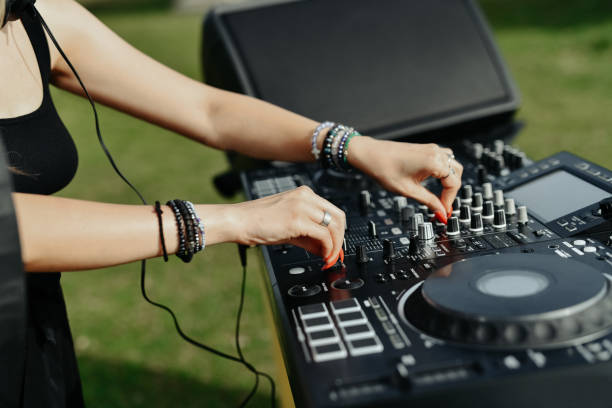 istock Female DJ Mixing Up Volume On Turntable 2164188206