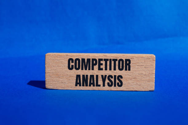 istock Competitor analysis message written on wooden block with blue background 2164189502