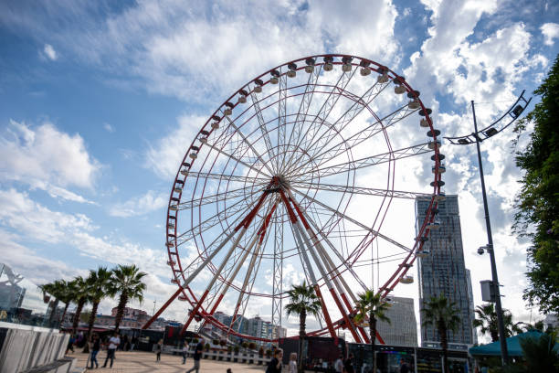 istock Red and White Ferris Wheel Against Blue and Cloudy Sky with Copy Space 2164190791