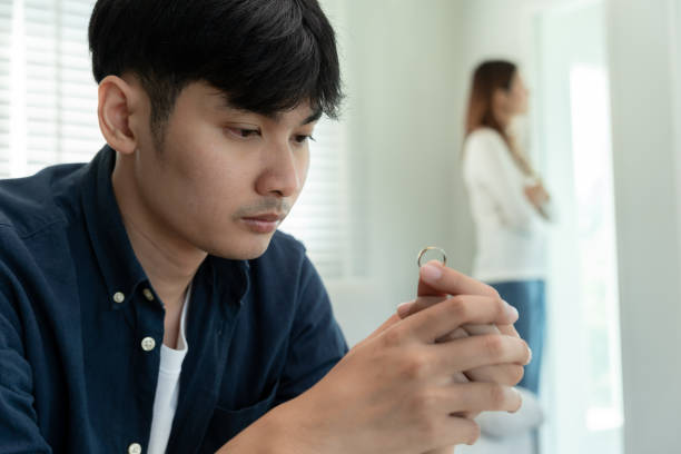 istock Divorce. Man remove married ring. Couples desperate and disappointed after marriage. Husband wife sad, upset and frustrated after quarrels conflict. distrust, love problems, betrayals, family, lover 2164191255
