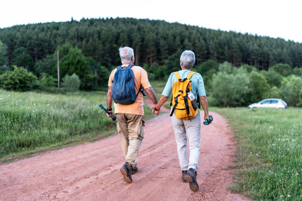 istock Senior couple is hiking in forest 2164195388