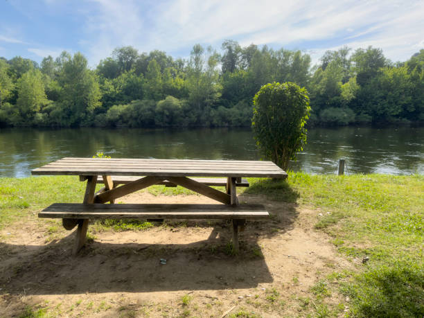istock empty wooden picnic table in the park by river 2164197131